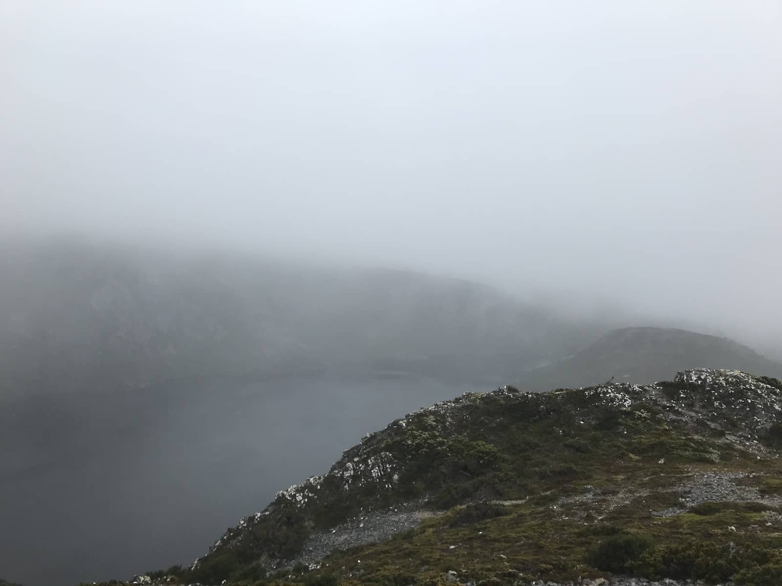 Part of a mountain on a very cloudy day