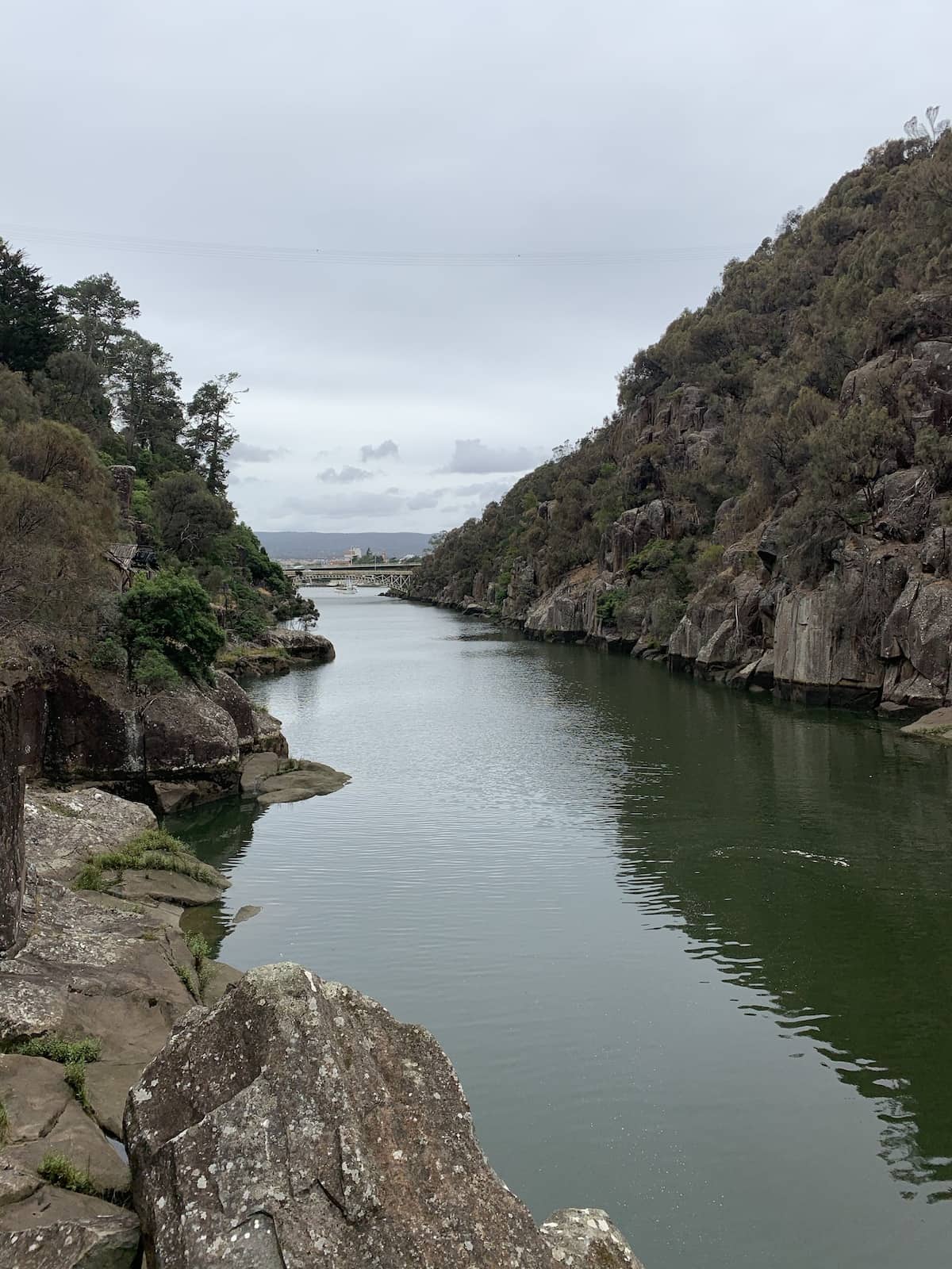 A view down a gorge, where a bridge can be seen in the distance