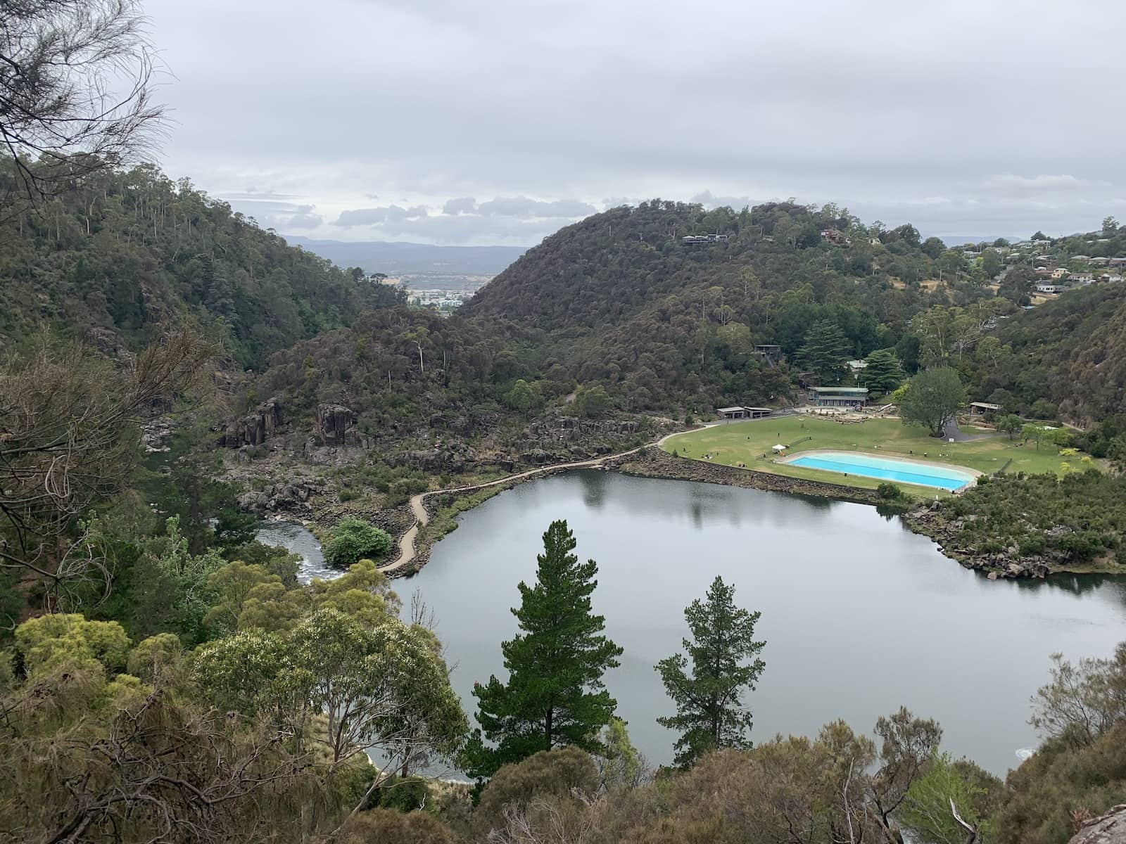 A view from a lookout into a basin. There is a pool on one side of the basin