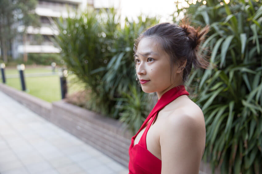 Slight side view of the woman with her hair in a bun.