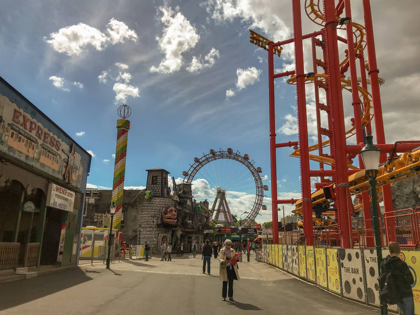 The same amusement park from previous photos, showing a ferris wheel and a red painted mouse-trap style ride to the right