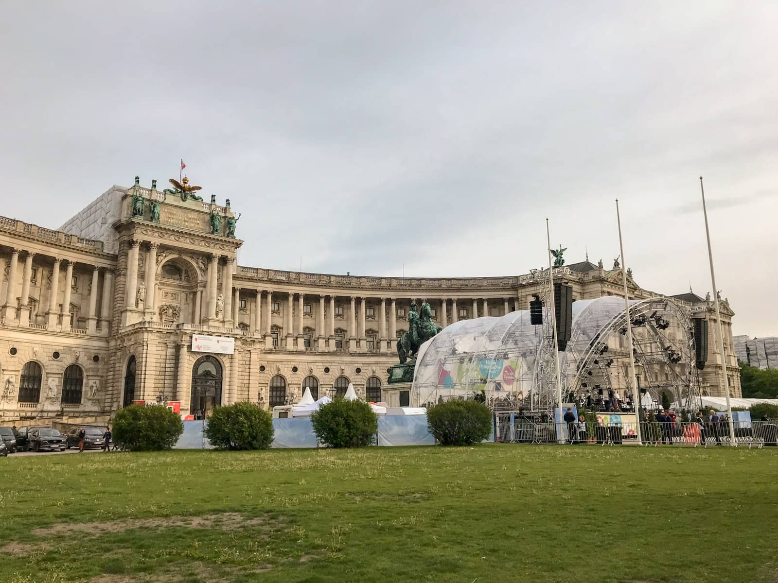 A palace with an outdoor stage being set up.