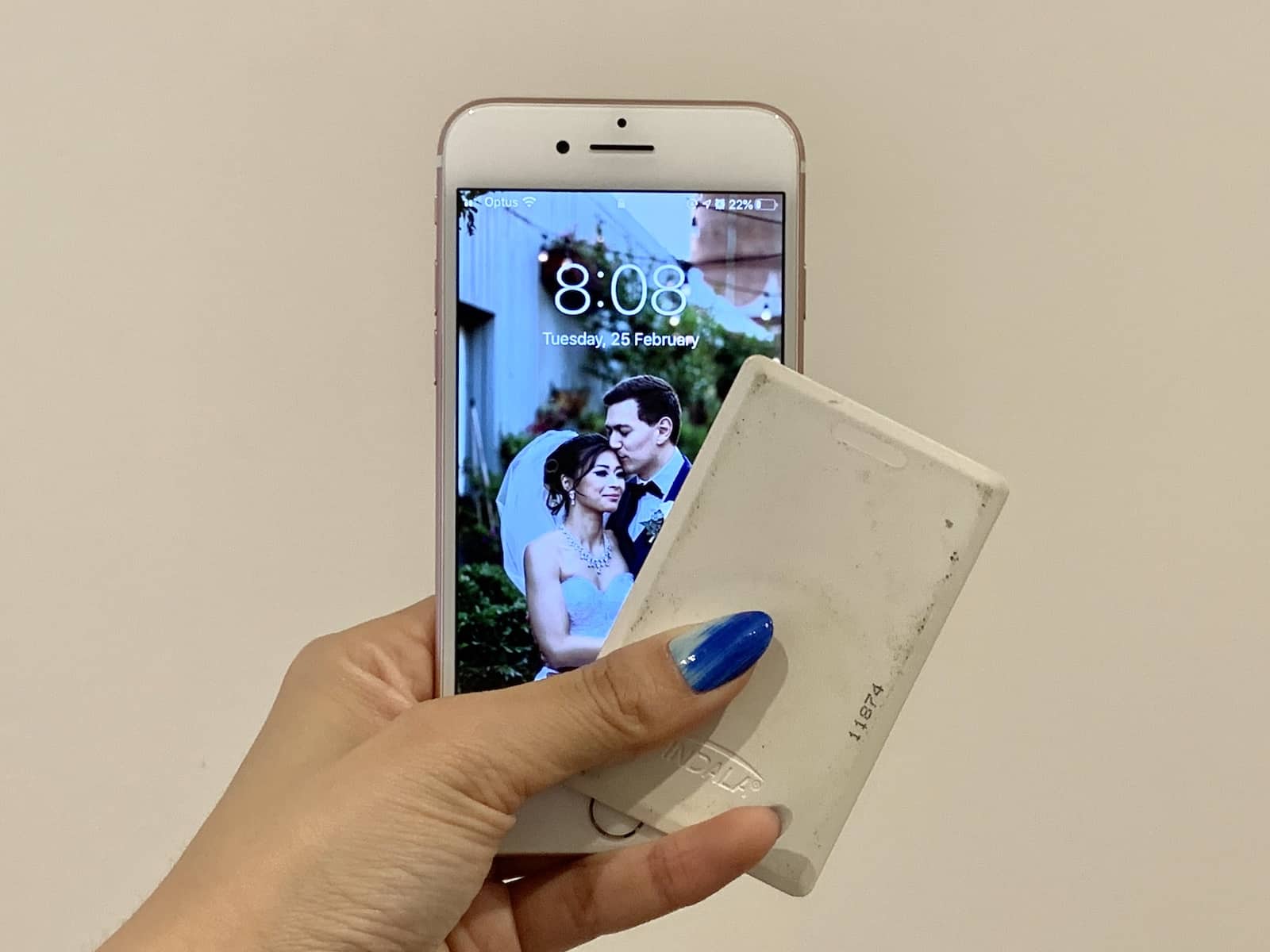 A woman’s hand holding a smartphone and card