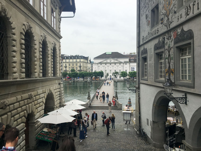 View down the stairs leading to a bridge over water in Lucerne
