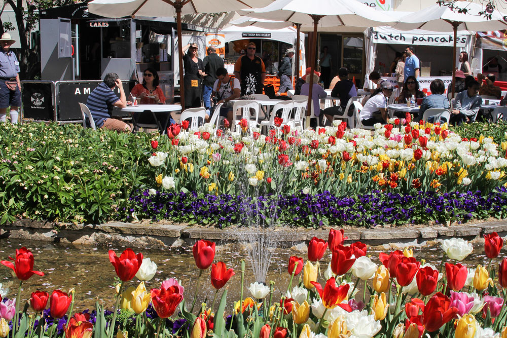 Water fountain. Dutch pancakes stall in the background