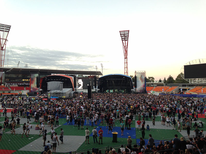 A huge crowd gathers for Pearl Jam, exceeding the fenced off area in front of the stage