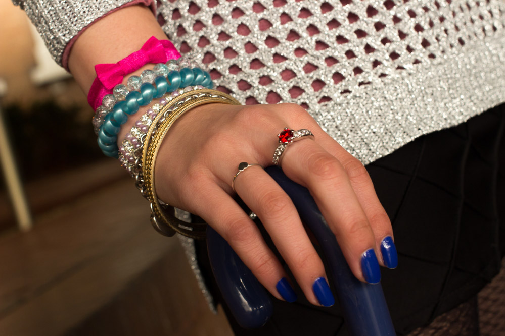 An arm party – bangles, bracelets, and a red ring