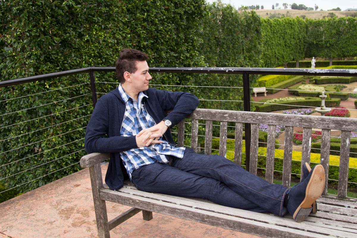 Laying on a bench overlooking a garden display