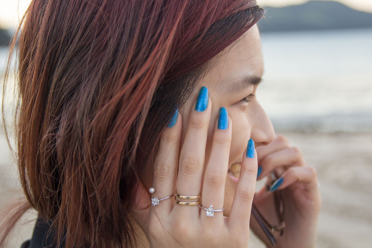 Blue nail polish and mixed set of rings