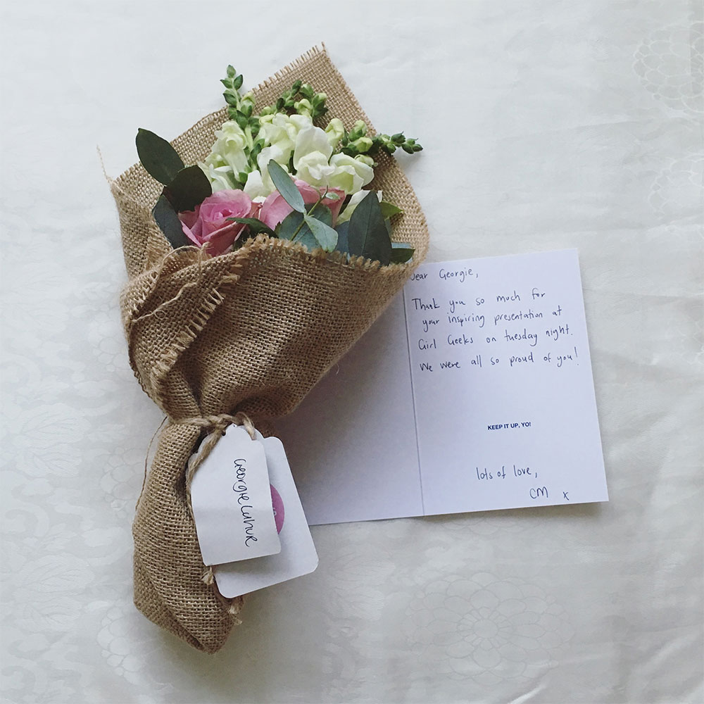 A small bouquet of flowers and a card from work