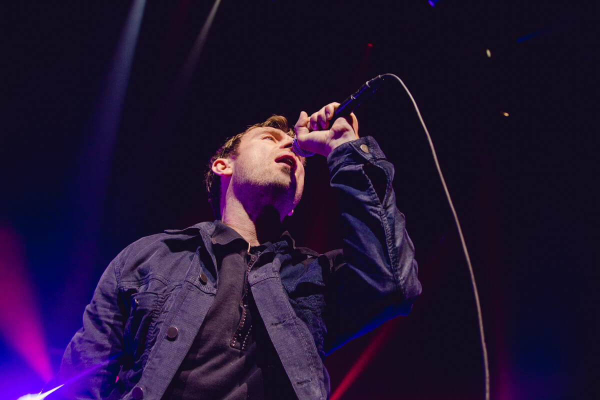 Low angle shot of Damon singing