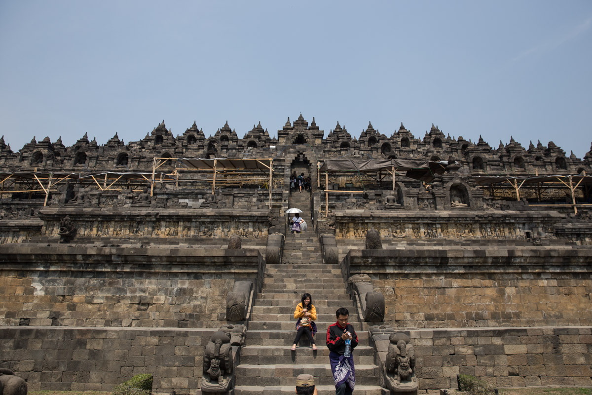 Front view of people going up the temple steps 
