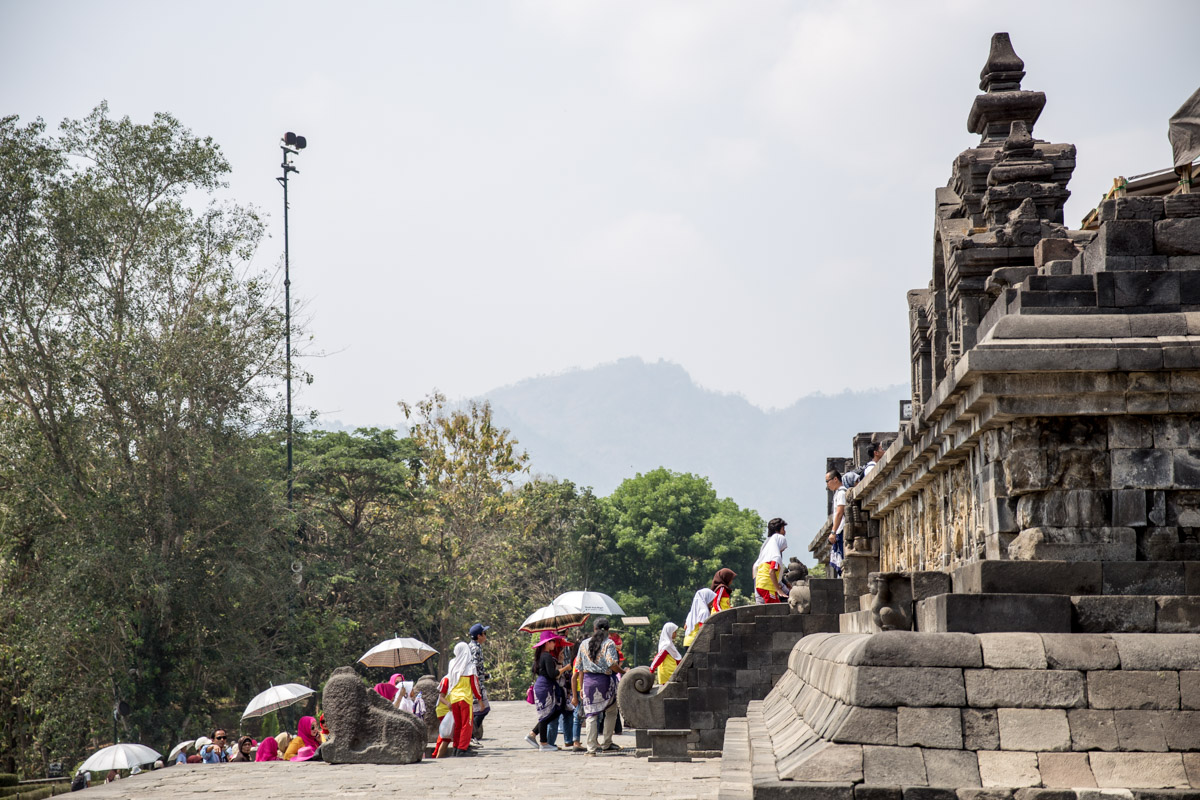 People approaching the steps to the temple