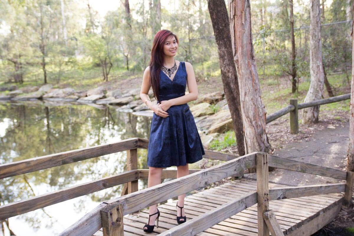 Full body shot standing on a wooden bridge