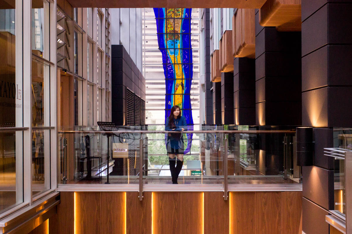 Standing on an indoor bridge walkway 