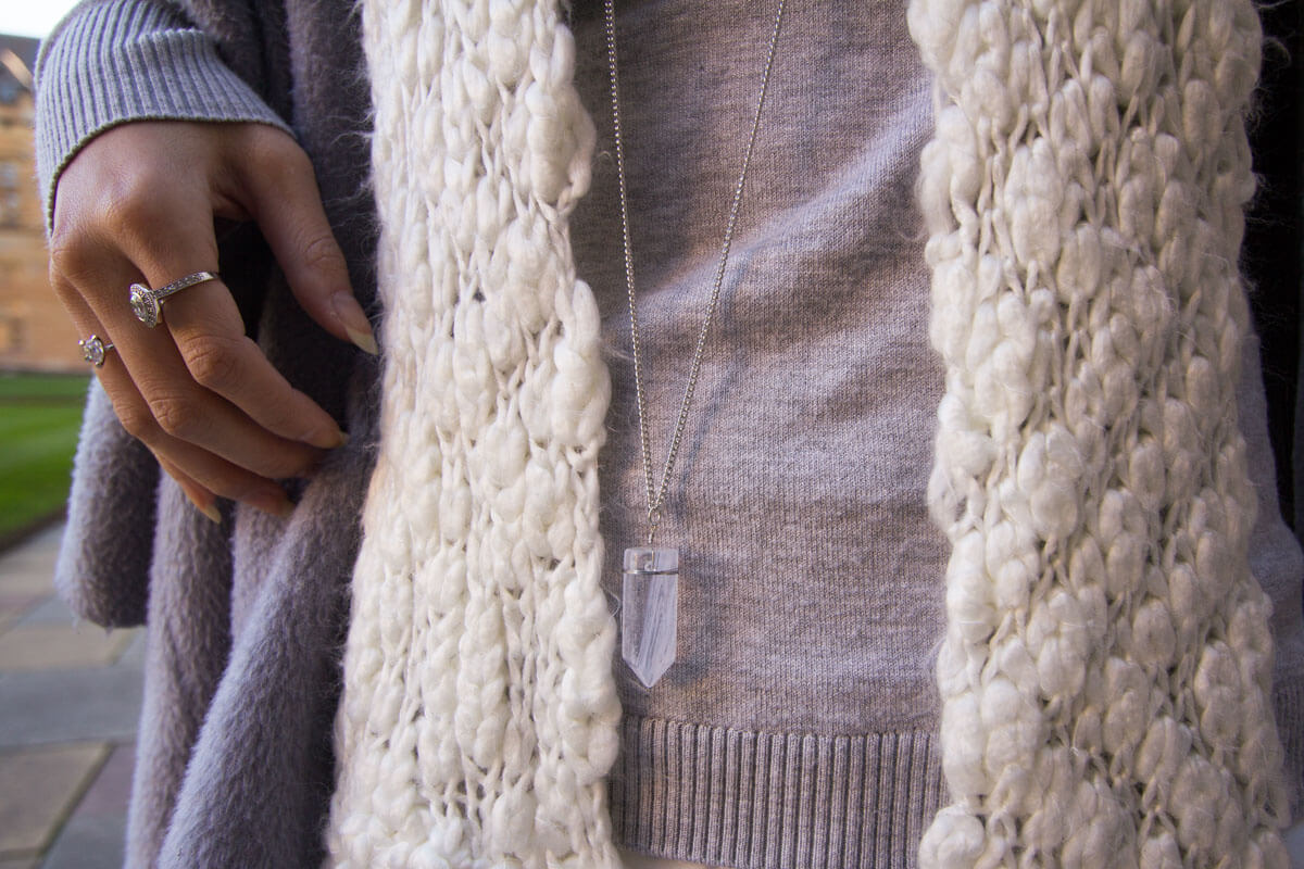 Close up of semi precious stone pendant and scarf details