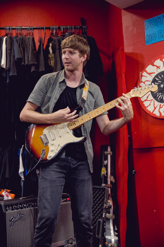 Ross playing guitar and singing.