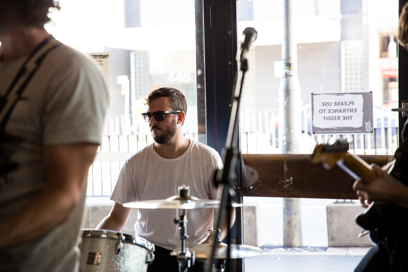 Tony wearing sunglasses as he plays the drums.