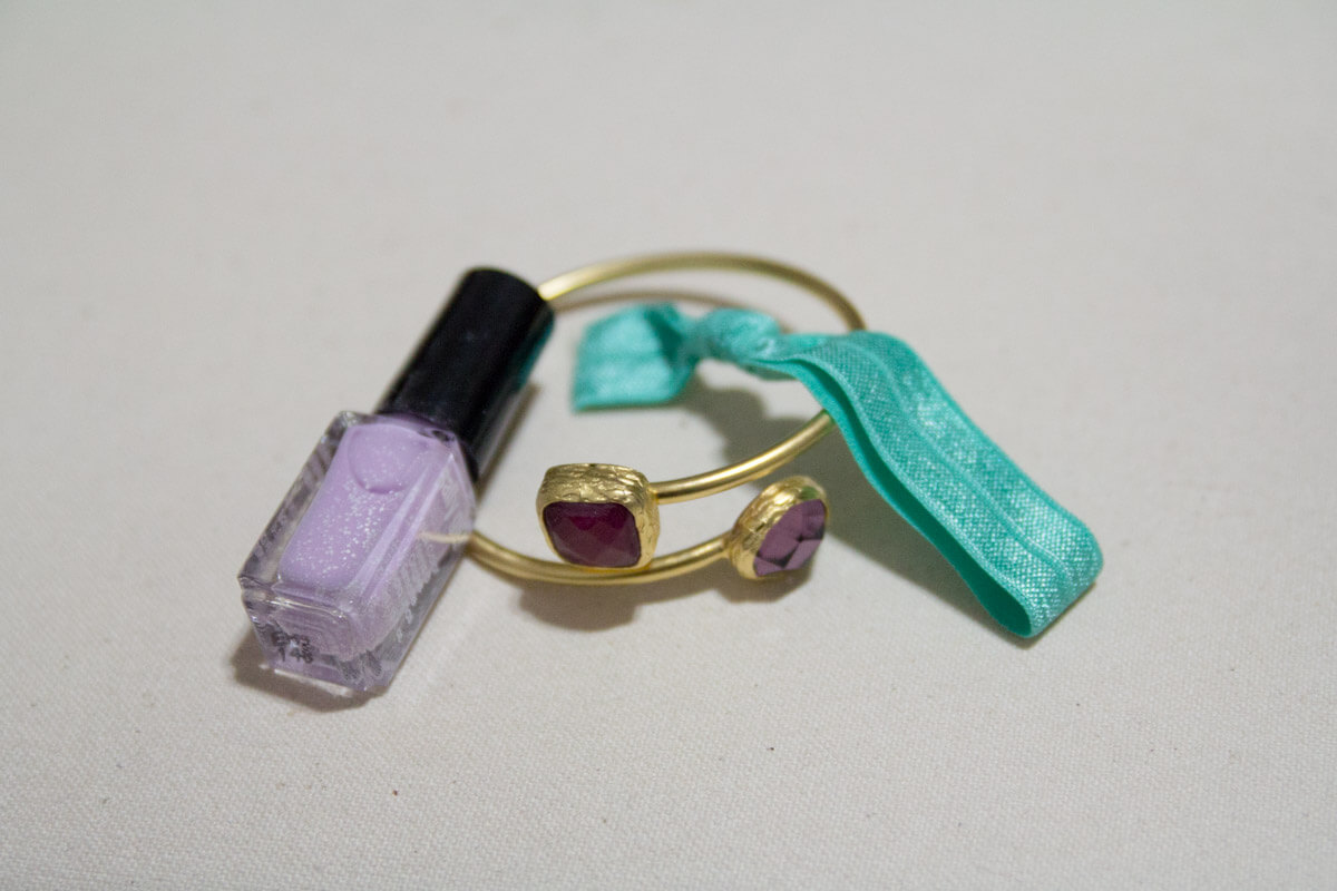 The bangle with the nail polish and hair tie