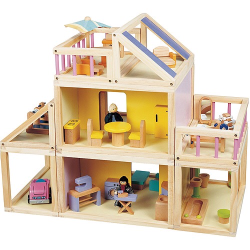 A wooden doll house with furniture, but no doors between the rooms